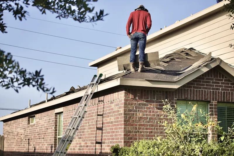 Professional roofer working on a residential roof in Twin Bridges